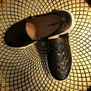 Slightly worn black quilted slip on sneakers. Size 6.